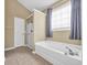 Bathroom showcases a soaking tub, glass-enclosed shower, large window, and a tile floor at 1139 Parish Way, Myrtle Beach, SC 29577