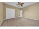Neutral bedroom with a ceiling fan, carpet flooring, and a double-door closet providing ample storage space at 1139 Parish Way, Myrtle Beach, SC 29577