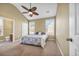 Cozy bedroom featuring a patterned bed, vaulted ceiling, two bright windows, and an en suite bathroom at 1139 Parish Way, Myrtle Beach, SC 29577