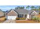 Inviting home with a brick facade, manicured landscaping, and a two-car garage on a sunny day at 1139 Parish Way, Myrtle Beach, SC 29577