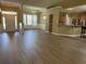 Open-concept living space with hardwood flooring, modern lighting, and seamless flow to the kitchen at 1139 Parish Way, Myrtle Beach, SC 29577