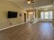 Bright living room featuring hardwood floors, neutral paint, and a partial view of the home's entryway at 1139 Parish Way, Myrtle Beach, SC 29577