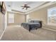 Spacious main bedroom with plush carpet, tray ceilings, large windows, and a ceiling fan at 1139 Parish Way, Myrtle Beach, SC 29577
