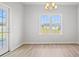 Bright dining room featuring a chandelier, a large window overlooking a manicured lawn, and wood floors at 1209 Cypress Shoal Dr., Conway, SC 29526