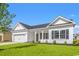 Charming single-story home featuring a two-car garage, welcoming front porch, and manicured lawn at 1209 Cypress Shoal Dr., Conway, SC 29526