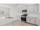 Modern kitchen with stainless steel appliances, white cabinets, quartz countertops and herringbone backsplash at 1209 Cypress Shoal Dr., Conway, SC 29526