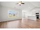 Open-concept living area with a large window, hardwood floors, and a view of the kitchen at 1209 Cypress Shoal Dr., Conway, SC 29526
