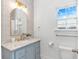 Bathroom with decorative wallpaper, a marble sink, gold fixtures, and lots of natural light at 210 26Th Ave. S, Myrtle Beach, SC 29577
