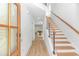 Bright entryway with wood flooring, staircase with wood treads and metal railings, and a view into the living area at 210 26Th Ave. S, Myrtle Beach, SC 29577