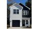 Charming two-story home with modern design, featuring black and white exterior and a well-manicured lawn at 210 26Th Ave. S, Myrtle Beach, SC 29577
