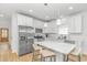 Modern white kitchen with stainless steel appliances, a large center island, and bar stool seating at 210 26Th Ave. S, Myrtle Beach, SC 29577