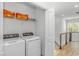 Laundry room with washer and dryer, wire rack for storage, and natural light from nearby windows at 210 26Th Ave. S, Myrtle Beach, SC 29577