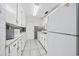 Long kitchen with white cabinets, tile backsplash, and stainless steel appliances at 4502 Eyerly St., North Myrtle Beach, SC 29582
