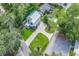 Aerial view of a charming home with a metal roof, a circular driveway, and lush green landscaping at 613 Lee Ave., Murrells Inlet, SC 29576