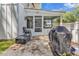 Exterior view of the home's screened porch and patio with a grill and outdoor seating at 613 Lee Ave., Murrells Inlet, SC 29576