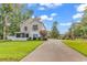 Inviting two-story home featuring a screened-in porch and long driveway at 613 Lee Ave., Murrells Inlet, SC 29576