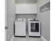 Modern laundry room featuring a full-sized washer and dryer, plus overhead cabinets for storage at 613 Lee Ave., Murrells Inlet, SC 29576