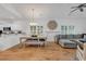 Open-concept living space featuring hardwood floors, a dining table, and a comfortable sectional sofa at 613 Lee Ave., Murrells Inlet, SC 29576