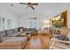 Comfortable living room with hardwood floors, sectional sofa, and windows with shutter blinds at 613 Lee Ave., Murrells Inlet, SC 29576