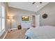 Lovely bedroom with a television over an antique-white cabinet and light-gray walls and carpet at 613 Lee Ave., Murrells Inlet, SC 29576