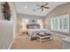 Comfortable bedroom with a king bed, ceiling fan, two windows, and an eye-catching driftwood art piece at 613 Lee Ave., Murrells Inlet, SC 29576