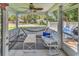 Inviting screened porch with a hammock, ceiling fan, and a view of the neighborhood at 613 Lee Ave., Murrells Inlet, SC 29576