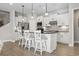 Bright kitchen featuring white cabinets, a center island with seating, and modern appliances at 7246 Sarteano Dr., Myrtle Beach, SC 29572