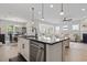 Open kitchen features a black island, stainless steel appliances, and hardwood floors at 7246 Sarteano Dr., Myrtle Beach, SC 29572