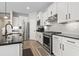 Well-equipped kitchen featuring stainless steel appliances, black countertops, and subway tile backsplash at 7246 Sarteano Dr., Myrtle Beach, SC 29572