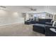 This neutral-colored living room features a ceiling fan, carpet, and a large sectional sofa at 7246 Sarteano Dr., Myrtle Beach, SC 29572
