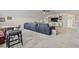 A carpeted living room features a huge sectional sofa, ceiling fan, and TV area at 7246 Sarteano Dr., Myrtle Beach, SC 29572