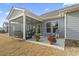 Exterior patio space with screened porch, flowers in pots, and a comfortable seating area at 7246 Sarteano Dr., Myrtle Beach, SC 29572