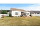 Backyard view featuring a screened porch, patio with outdoor furniture, grill, and landscaped yard at 1004 Millsite Dr., Conway, SC 29526