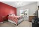 Bedroom with red accent wall, ceiling fan, and bright window at 1004 Millsite Dr., Conway, SC 29526
