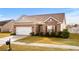 Beautiful brick home with a two-car garage and manicured front lawn at 1004 Millsite Dr., Conway, SC 29526