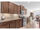 Modern kitchen with granite countertops, wooden cabinets and stainless steel appliances at 1004 Millsite Dr., Conway, SC 29526