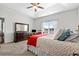 Bright main bedroom with a tray ceiling, large window, dresser, and rocking chair at 1004 Millsite Dr., Conway, SC 29526