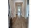 Inviting hallway with wood-look flooring, framed doorways, and modern wainscoting at 1240 Winding Creek Way, Myrtle Beach, SC 29588