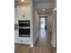 Modern kitchen with stainless steel appliances, white cabinetry, and stylish lighting at 1240 Winding Creek Way, Myrtle Beach, SC 29588