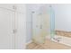 Bright bathroom boasts a glass enclosed shower, tub and clean white cabinets at 126 Pickering Dr., Murrells Inlet, SC 29576