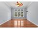 Bedroom with hardwood floors, ceiling fan, and natural light from large windows at 126 Pickering Dr., Murrells Inlet, SC 29576