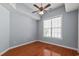 A naturally lit bedroom with hardwood floors, ceiling fan, and a large window at 126 Pickering Dr., Murrells Inlet, SC 29576
