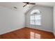 An empty bedroom with hardwood floors, ceiling fan, vaulted ceiling and a large window at 126 Pickering Dr., Murrells Inlet, SC 29576