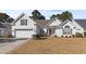 Charming one-story home featuring a manicured lawn, attached garage, and inviting front porch at 126 Pickering Dr., Murrells Inlet, SC 29576