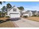 Inviting one-story home with a lush lawn, brick-trimmed driveway, and attached two-car garage at 126 Pickering Dr., Murrells Inlet, SC 29576