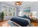 Bedroom with a large bed, blue accent rug, and natural light from large windows at 126 Pickering Dr., Murrells Inlet, SC 29576
