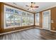Bright sunroom with large windows, wood-look flooring, and a ceiling fan at 126 Pickering Dr., Murrells Inlet, SC 29576
