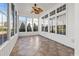 Bright sunroom features neutral tile, a decorative ceiling fan, and large windows at 126 Pickering Dr., Murrells Inlet, SC 29576