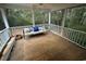 Screened back porch with comfortable bench seating and a ceiling fan perfect for relaxing and enjoying the outdoors at 187 Alston Rd., Pawleys Island, SC 29585