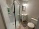 This bathroom features a shower with glass doors, white sink, and tile floors at 187 Alston Rd., Pawleys Island, SC 29585